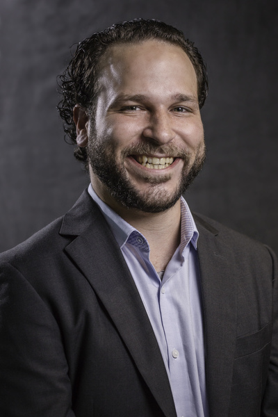 Mathematical Sciences Assistant Professor Carlos Arreche won the 2020 teaching award for tenure-track professors, wears a dark jacket with an open collar shirt.
